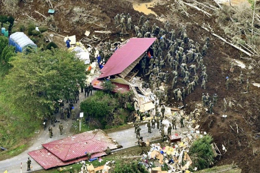 Members of the Japan Self-Defense Forces (JSDF) search for survivors from a house damaged by a landslide caused by an earthquake in Atsuma town, Hokkaido, northern Japan, in this photo taken by Kyodo on Friday — Kyodo photo via Reuters