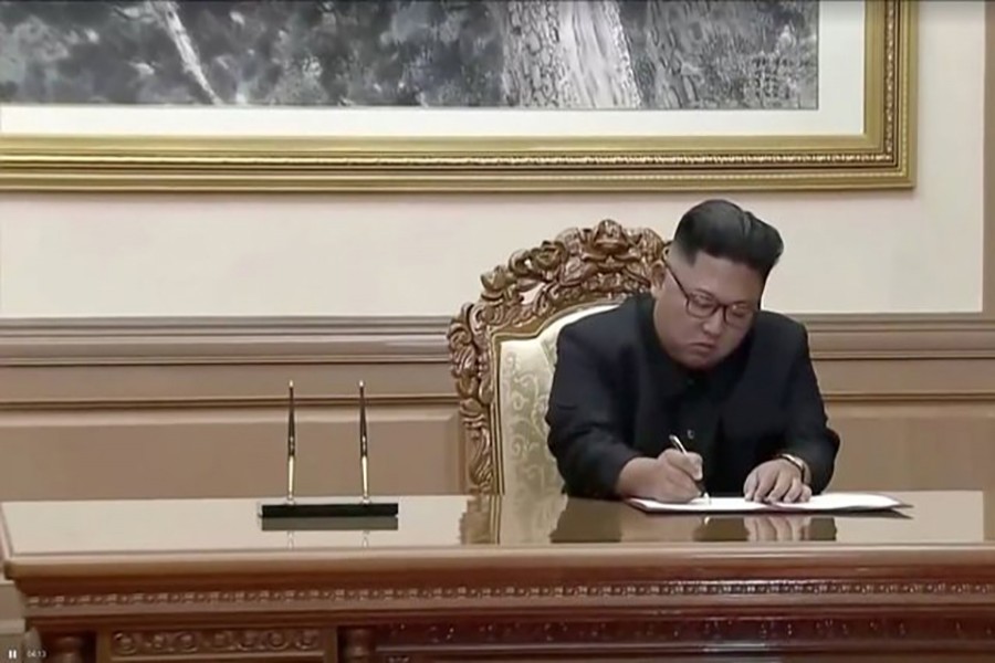 North Korean leader Kim Jong Un signs documents during the inter-Korean summit at the Paekhwawon State Guesthouse in Pyongyang, North Korea in this still frame taken from video on Wednesday — Reuters