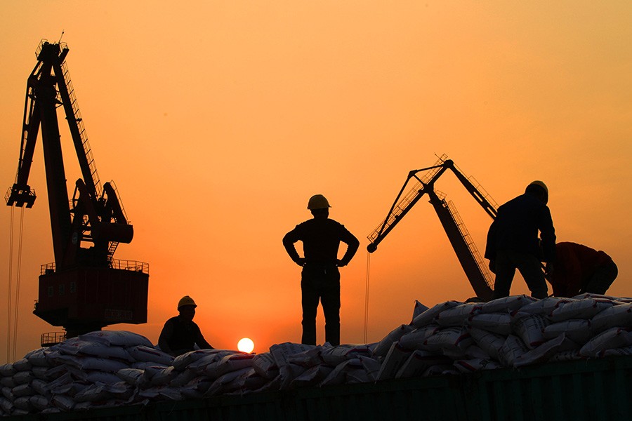 Workers load imported goods at a port in Nantong, Jiangsu province on February 24, 2016 — Reuters/File