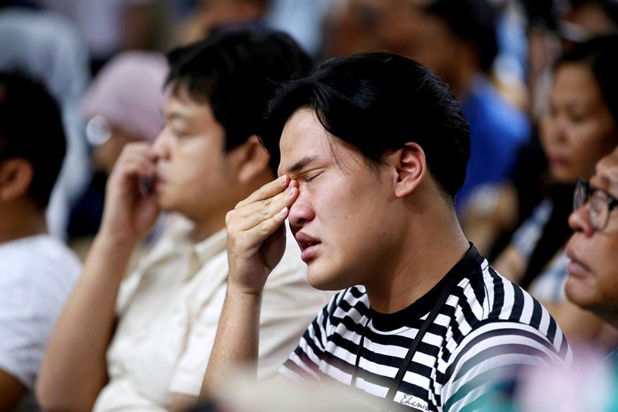 A man, who had family on the crashed Lion Air flight JT610, crying at a news conference about the recovery process at a hotel in Jakarta of Indonesia on Monday. -Reuters Photo