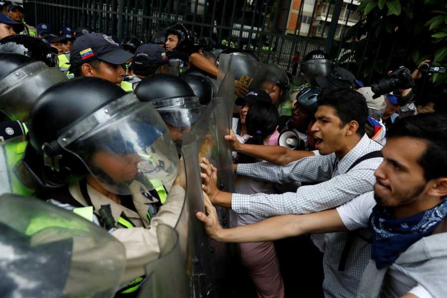 Opposition supporters confronted riot security forces while rallying against President Nicolas Maduro in Caracas, Venezuela, on Friday -Photo Credit: Carlos Garcia Rawlins/Reuters