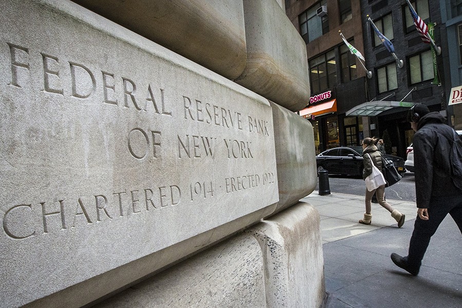 Pedestrians seen walking past the Federal Reserve Bank of New York building in New York, US in this undated Reuters photo
