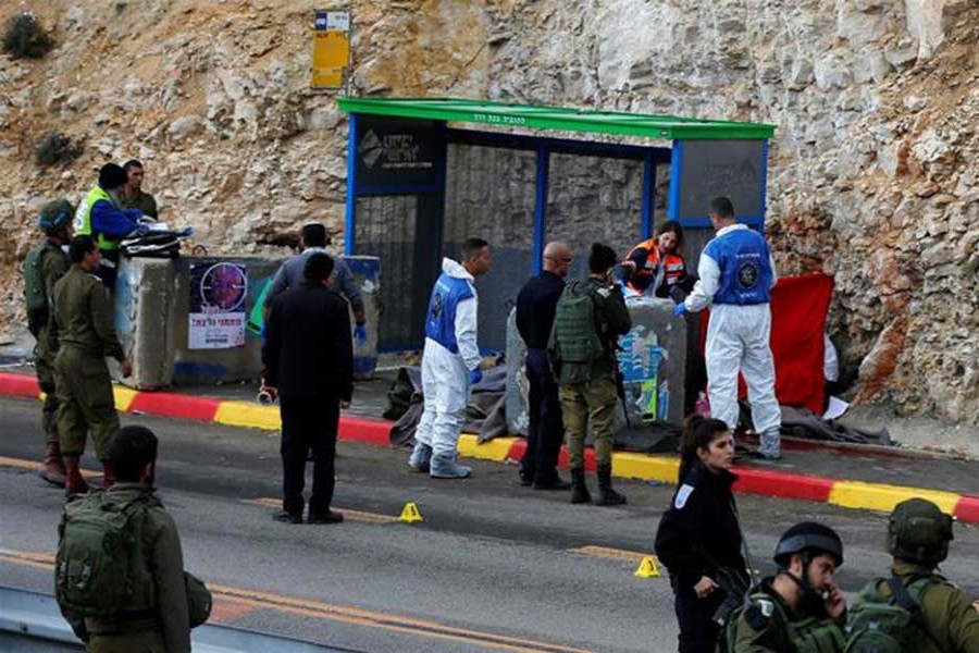 Israeli forces and medics at the scene of a shooting attack near Ramallah in the Israeli-occupied West Bank.  - Reuters