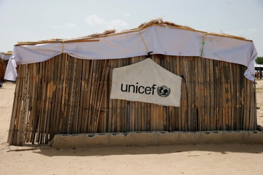 A banner with the UNICEF logo is seen hanging on a makeshift school at an internally displaced persons (IDP) camp on the outskirts of Maiduguri, north-east Nigeria June 6, 2017 - REUTERS/Akintunde Akinleye/File Photo