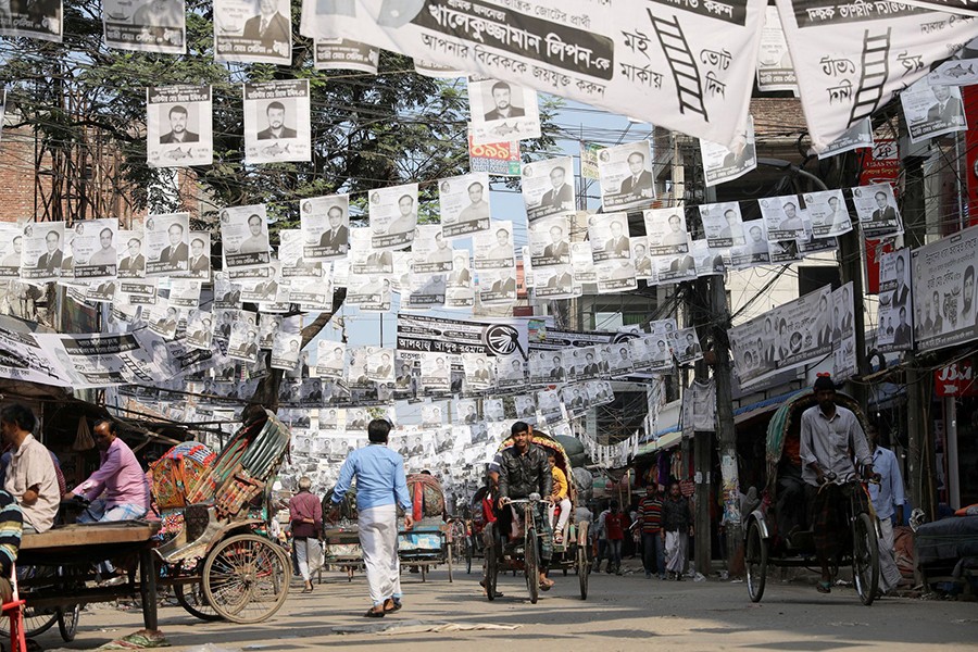 Posters are seen hanging on the street as part of the election campaign, ahead of the 11th general election in Dhaka, Bangladesh on December 24, 2018 — Reuters