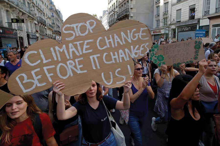 Protesters march to urge politicians to act against climate change in Paris on October 13, 2018. 	— Reuters