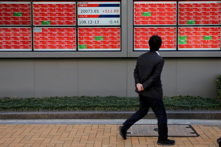A man looks at an electronic board showing the Nikkei stock index outside a brokerage in Tokyo, Japan, January 7, 2019. Reuters