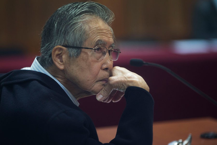 Former Peruvian President Alberto Fujimori, photographed through a glass window, at his trial on the outskirts of Lima, Peru, in June 2016 - AP