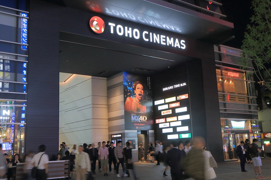 People in front of Toho Cinemas Shinjuku. Toho Cinemas is a Japanese film, theatre production and distribution company and famous for Godzilla movies. File photo