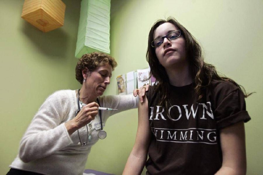 A young woman getting a vaccine shot. Reuters Photo