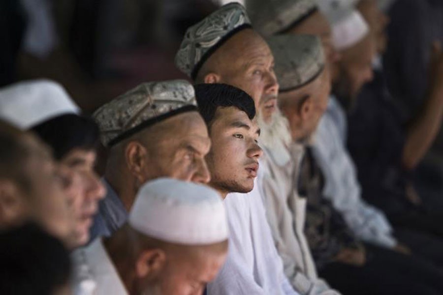 Uighur Muslim worshipers attend an early afternoon prayer session at the Kashgar Idgah mosque in Xinjiang province, Photo taken August 5, 2008 - Nir Elias/Reuters