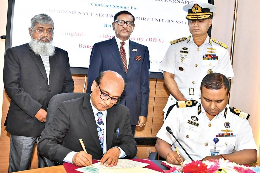 Road Transport and Bridges Minister Obaidul Quader witnessing the signing of a Tk 650 million contract on ensuring security and safety of the Karnaphuli tunnel during its construction period at Bangladesh Bridge Authority conference room in the capital on Monday