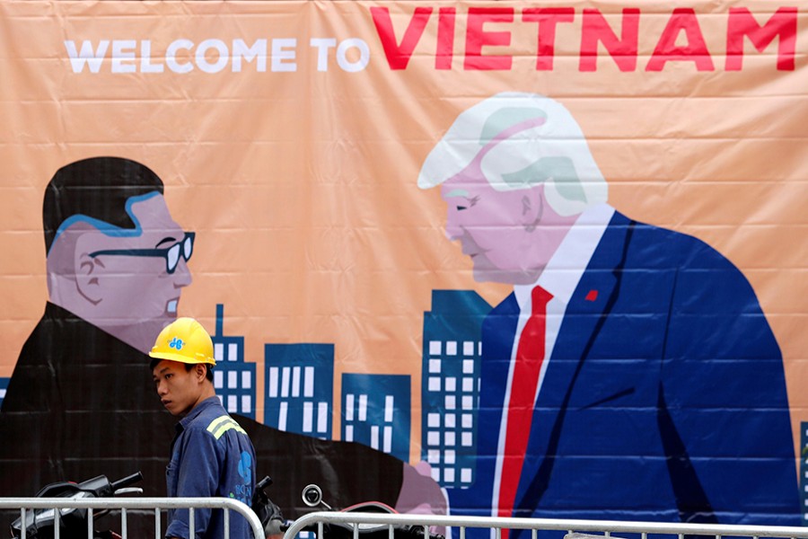 A man walks past a banner depicting North Korean leader Kim Jong-un and US President Donald Trump ahead of the North Korea-US summit in Hanoi, Vietnam — Reuters photo