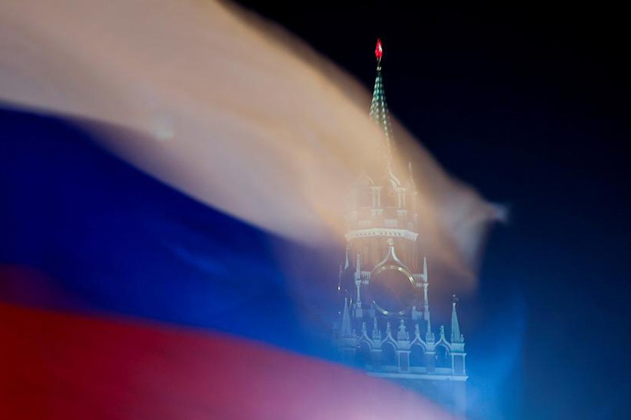 The Reuters file photo shows a Russian flag flies with the Spasskaya Tower of the Kremlin in the background in Moscow