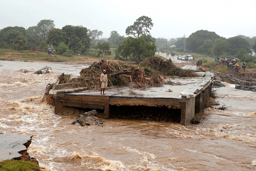 A man looks at a washed away bridge along Umvumvu river in Chimanimani, Zimbabwe on March 18, 2019 — Reuters photo