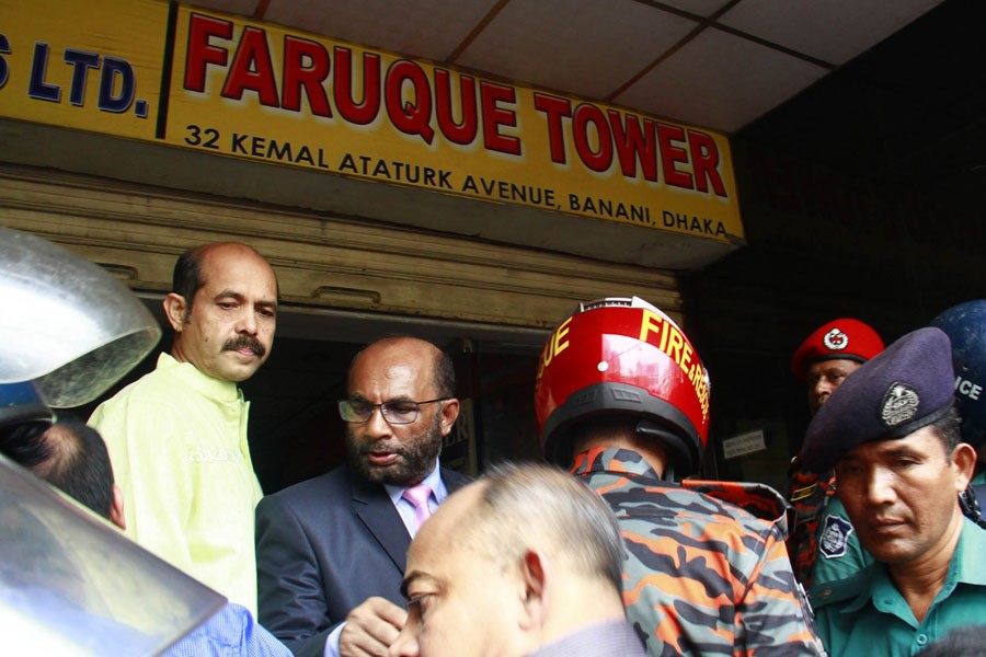 Housing and Public Works Minister SM Rezaul Karim talks to media persons on Friday morning, when he goes to visit the site of the FR Tower, where a deadly fire occurred a day before. Photo: Focus Bangla