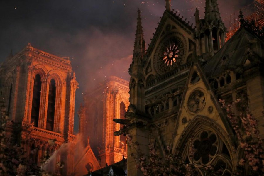 Sparks fill the air as Paris Fire brigade members spray water to extinguish flames as the Notre Dame Cathedral burns in Paris, France, April 15, 2019. Reuters