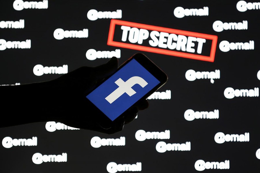 A person holds a smartphone with the Facebook logo in front of displayed "top secret" and "email" words, in this picture illustration taken on December 6, 2018 — Reuters/Files