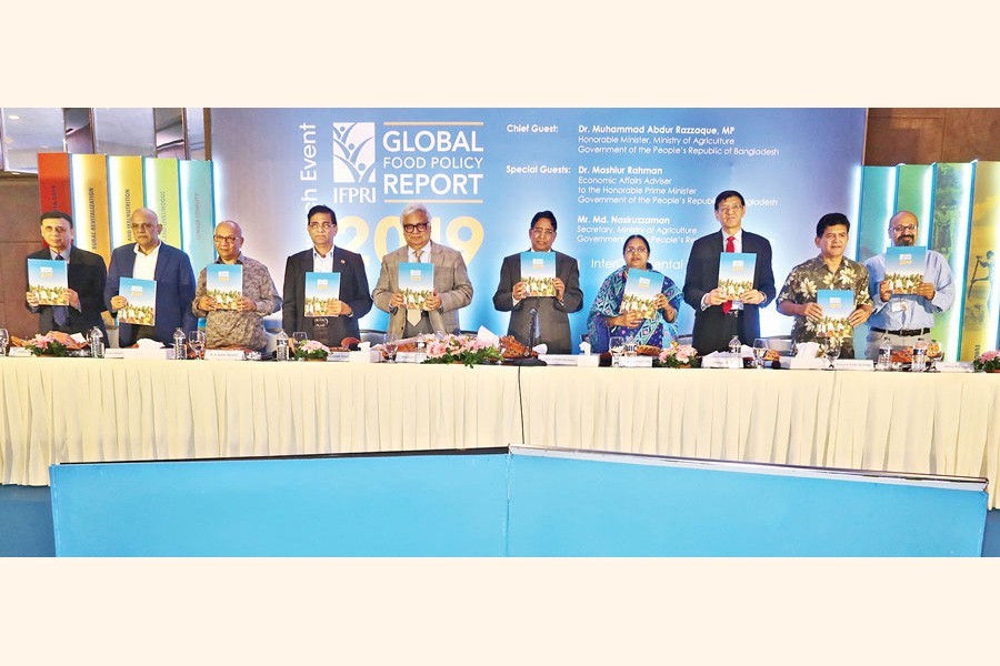 Agriculture Minister Dr Muhammad Abdur Razzaque and Prime Minister's Economic Affairs Adviser Dr Mashiur Rahman seen, among others, at the launching ceremony of IFPRI's Global Food Policy Report 2019 at a city hotel on Thursday — FE photo