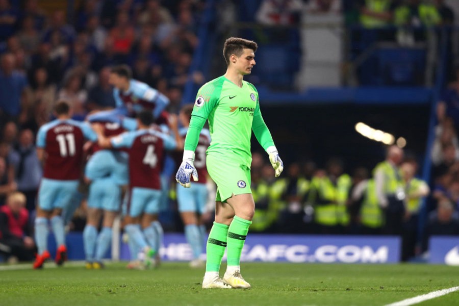 Chelsea's Kepa Arrizabalaga looking crestfallen as Burnley celebrate their first-half equaliser in the Premier League on Monday	— Internet
