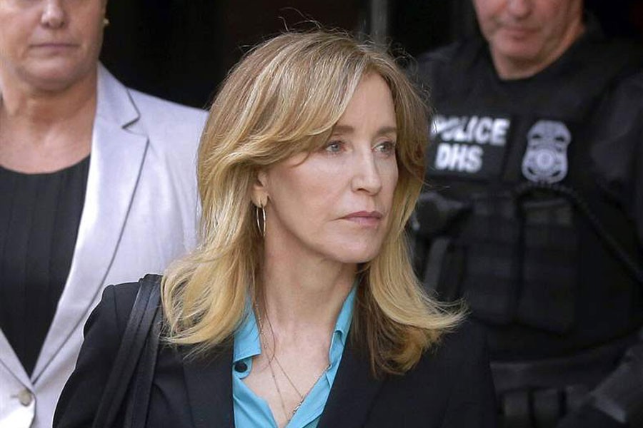 In this April 3, 2019 file photo, actress Felicity Huffman arrives at federal court in Boston to face charges in a nationwide college admissions bribery scandal. In a court filing on Monday, April 8, 2019, Huffman agreed to plead guilty in the cheating scam - AP Photo/Steven Senne, File