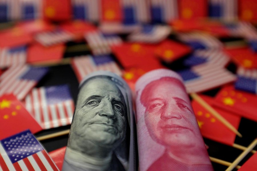 A US dollar banknote featuring American founding father Benjamin Franklin and a China's yuan banknote featuring late Chinese chairman Mao Zedong are seen among US and Chinese flags in this illustration picture taken May 20, 2019. Reuters/Illustration