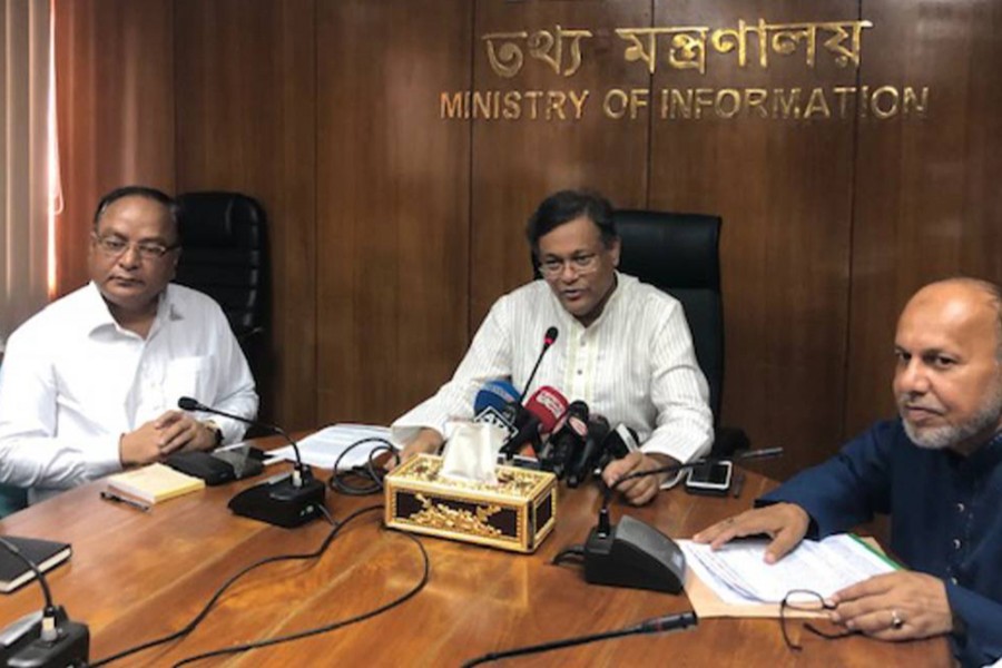 Information Minister Dr Hasan Mahmud (centre) talks to reporters during a views-exchange meeting with them at the Secretariat on Sunday — UNB photo