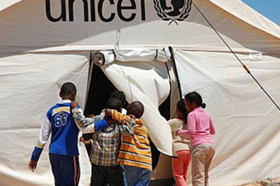 Children enter a UNICEF-supported tent school at the Shousha transit camp on the Libyan border with Tunisia - UNICEF/Heifel Ben Youssef