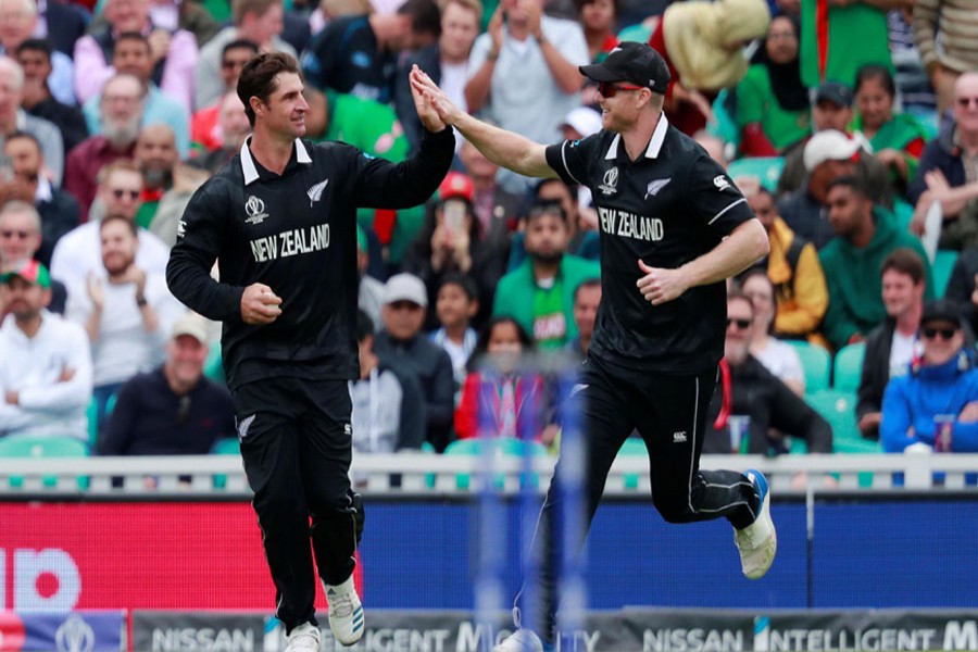 New Zealand's Trent Boult celebrates with team mates after taking the wicket of Bangladesh's Mehidy Hasan. Action Images via Reuters/Andrew Couldridge
