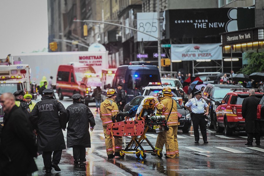 Emergency services personnel at the scene after a helicopter crashed atop a building in Times Square and caused a fire in the Manhattan borough of New York, New York, US on June 10, 2019 — Social media photo