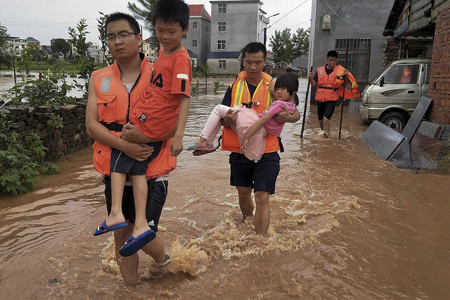 Rescuers transfer children as the floods hit Xiangxing Township of Yongxin County in Ji'an City, east China's Jiangxi Province on Sunday, June 9, 2019 — Xinhua photo via AP