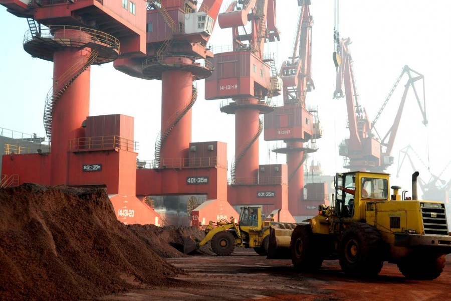 FILE PHOTO: Workers transport soil containing rare earth elements for export at a port in Lianyungang, Jiangsu province, China October 31, 2010 - REUTERS/Stringer