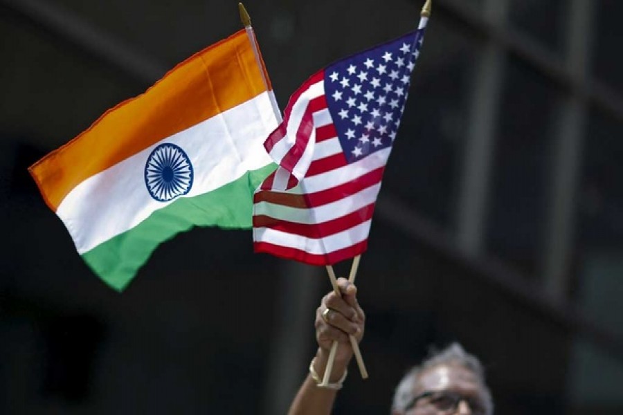 A man holds flags of India and the US while people take part in the 35th India Day Parade in New York, US August 16, 2015. Reuters/Files