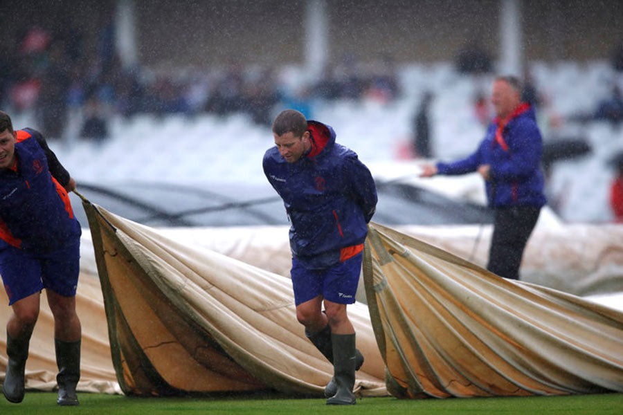 Ground staff putting covers on the pitch as rain delays a match, India v New Zealand, at Trent Bridge in Nottingham of Britain on June 13, 2019. -Reuters file photo