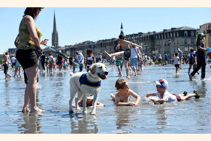 A family spending time in sea beach with their pet dog as temperature hit 40 degrees in France breaking the record for June   	— BBC