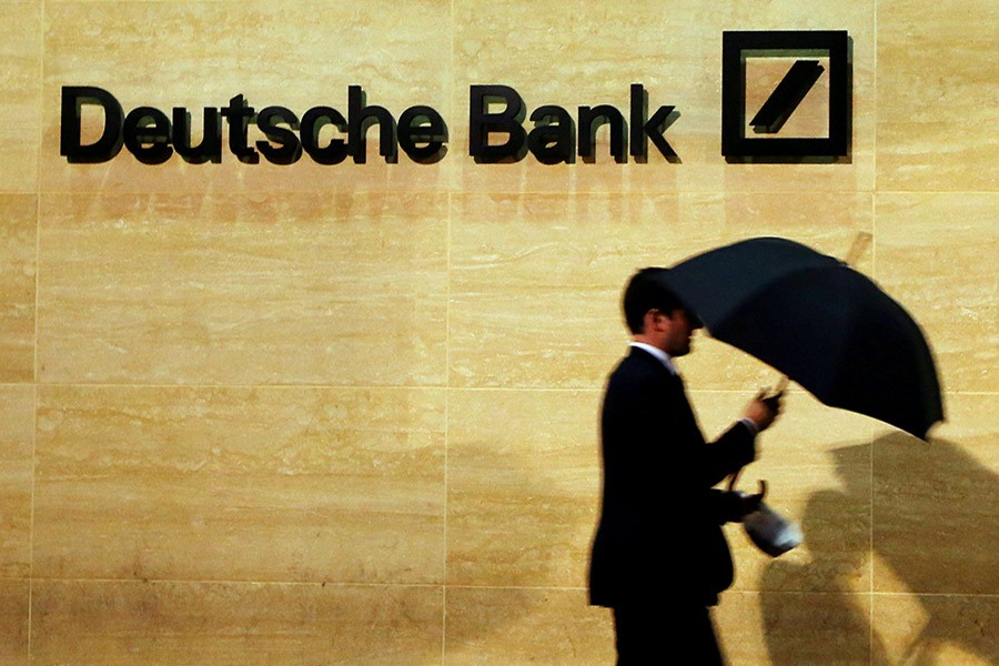 A man walks past Deutsche Bank offices in London December 5, 2013 — Reuters/Files