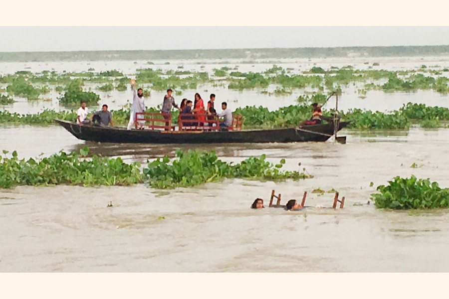 Two female passengers floating in the Padma as they fell off a boat near Sreerampore area in Rajshahi on Sunday	— FE Photo