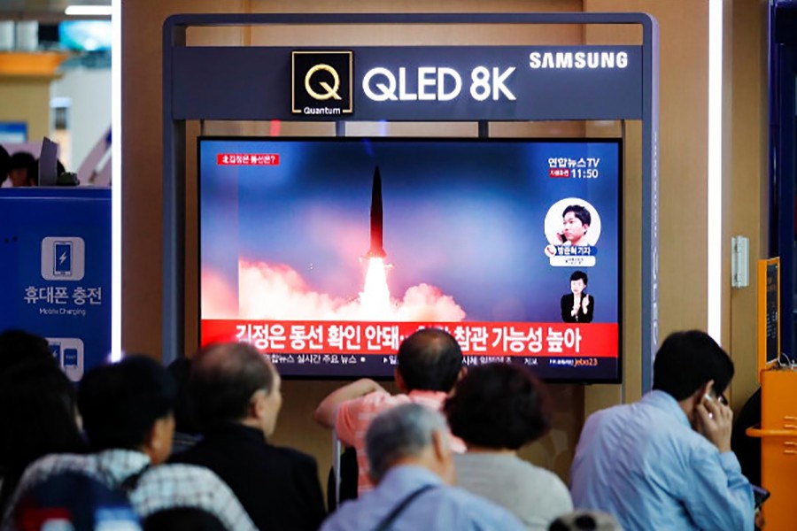 People watch a TV that shows a file picture of a North Korean missile for a news report on North Korea firing short-range ballistic missiles, in Seoul, South Korea on July 31, 2019 — Reuters photo