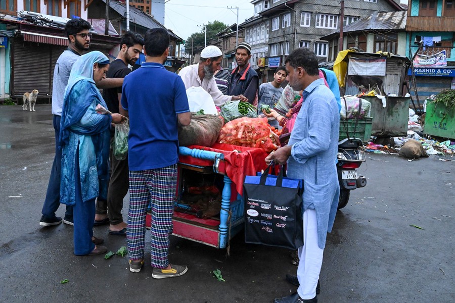 Muslims purchase food and vegetables during a lockdown in Srinagar
