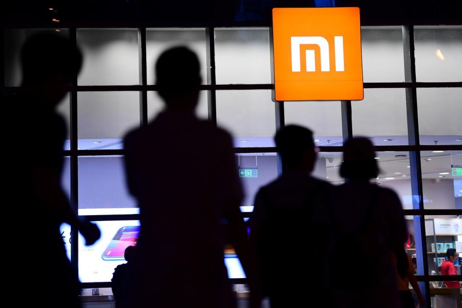 FILE PHOTO: People walk past a Xiaomi store in Shenyang, Liaoning province, China June 12, 2018. REUTERS/Stringer