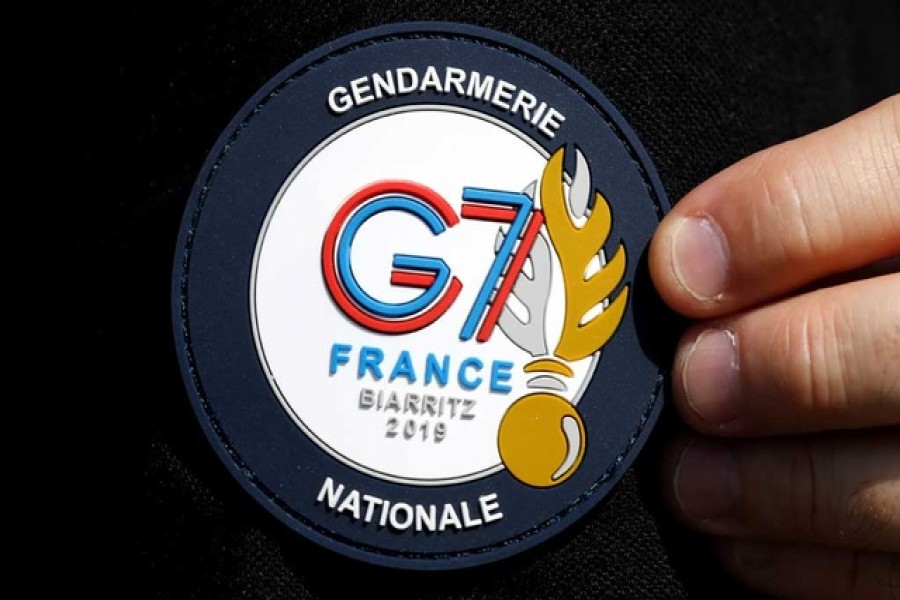 A G7 Summit patch is seen on a French Gendarme's uniform as he patrols at a toll station in Anglet ahead of the G7 Summit in the French coastal resort of Biarritz. Reuters