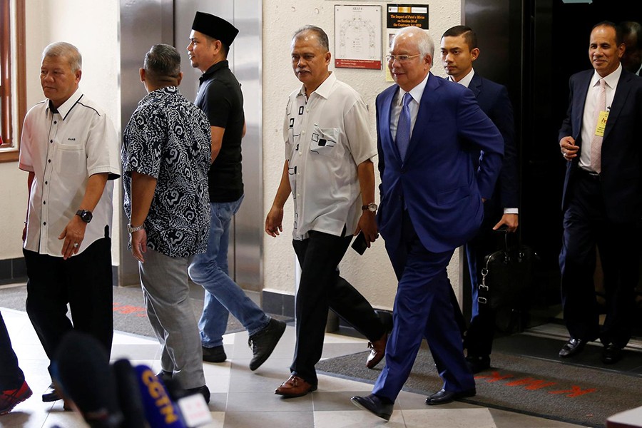 Former Malaysian Prime Minister Najib Razak (with glasses) walks to a courtroom after a break at Kuala Lumpur High Court in Kuala Lumpur, Malaysia on August 28, 2019 — Reuters photo