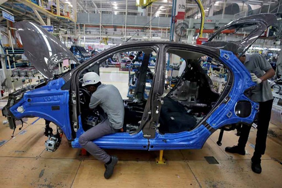Workers assemble a Tata Tiago car inside the Tata Motors car plant in Sanand, on the outskirts of Ahmedabad, India, August 7, 2018. Reuters/Files