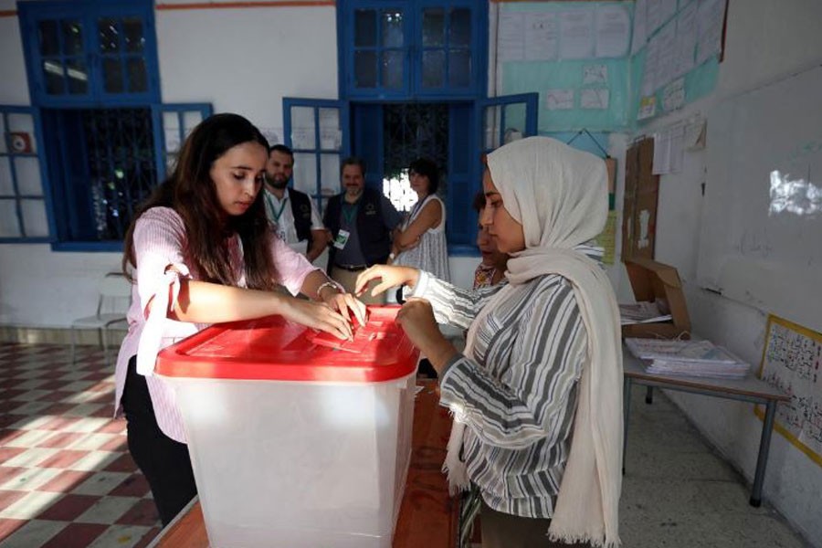Electoral workers prepare a ballot box inside a polling station during presidential election in Tunis, Tunisia, September 15, 2019. REUTERS/Muhammad Hamed