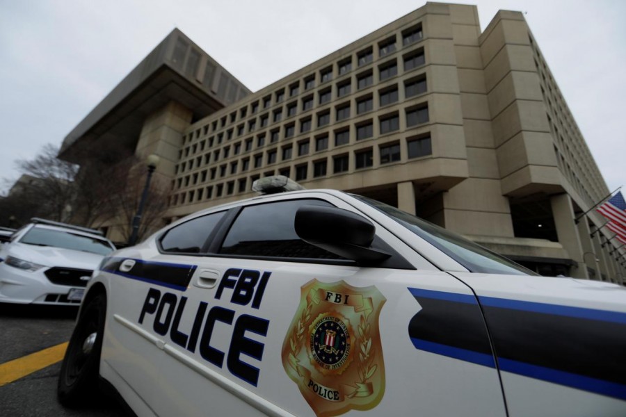 FILE PHOTO: FBI police vehicles sit parked outside of the J. Edgar Hoover Federal Bureau of Investigation Building in Washington, US, February 1, 2018. REUTERS/Jim Bourg