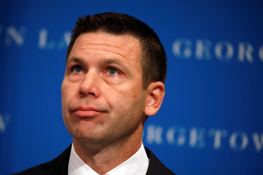 FILE PHOTO: Acting Department of Homeland Security (DHS) Secretary Kevin McAleenan reacts while protesters interrupt his remarks at the Migration Policy Institute annual Immigration Law and Policy Conference in Washington, U.S., October 7, 2019. REUTERS/Yuri Gripas