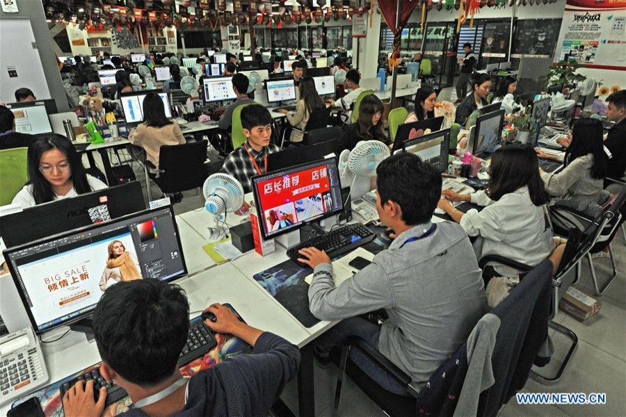 Staff members work at an e-commerce service company in Yiwu, east China's Zhejiang Province, on Oct 25, 2018 - Xinhua/Tan Jin