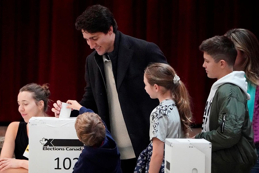 Justin Trudeau, with his family, puts his ballot for today's election in the ballot box in the Papineau area of Montreal, Quebec, Canada on October 21, 2019 — Reuters photo