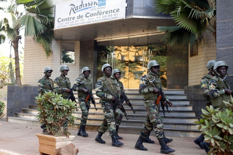 FILE- In this Saturday, Nov. 21, 2015 file photo, soldiers from the presidential guard patrol outside the Radisson Blu hotel in Bamako, Mali, after it was attacked by Islamic extremists armed with guns and grenades -  AP Photo / Jerome Delay, File