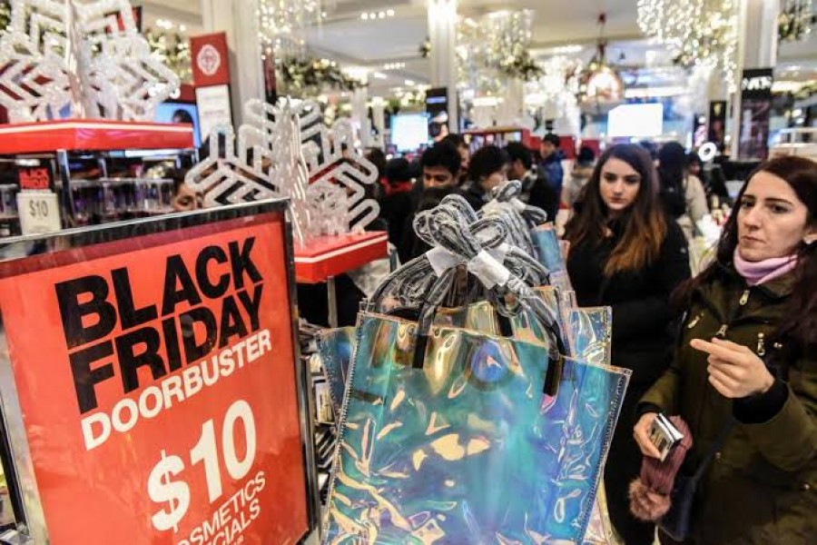 FILE PHOTO: People shop during a Black Friday sales event at Macy's flagship store on 34th St. in New York City, U.S., November 22, 2018. REUTERS/Stephanie Keith/File Photo